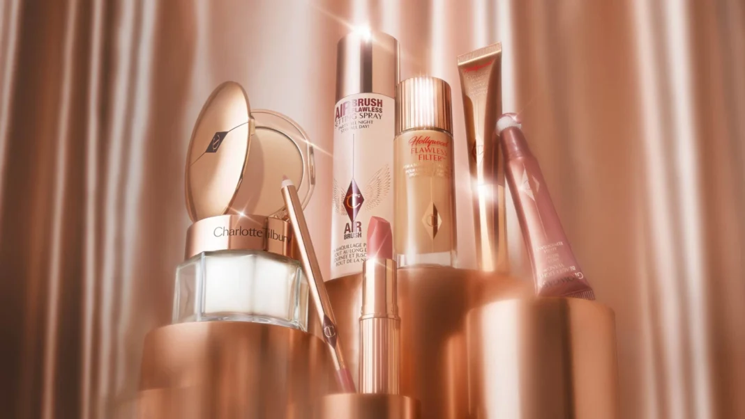 Charlotte Tilbury, British makeup artist and founder, smiling at a red carpet event with glowing makeup