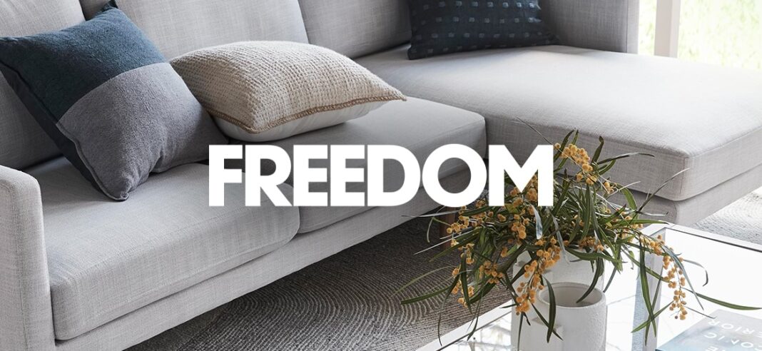 Modern Freedom Furniture sofa set in a cozy living room setting